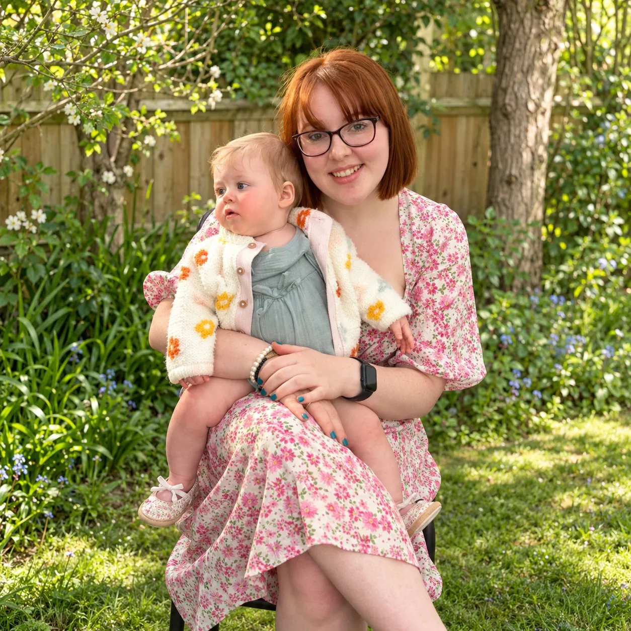 The Little Planets founder sitting in a garden with a baby on her lap